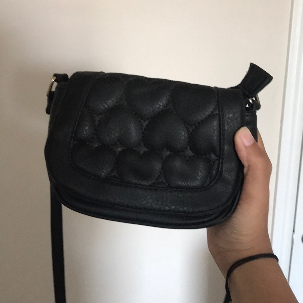 small black crossbody bag with stitched hearts